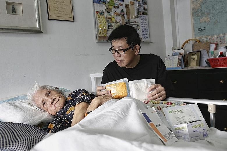 Mr Goh, 58, with his mother, Madam Seet, 84, who had a severe case of pressure ulcer on her spine and required an operation to remove the rotting flesh.