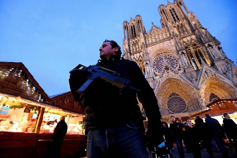 A French police officer patrolling the Christmas market in Reims on Tuesday, in the wake of the Berlin truck attack on Monday night which killed 12 people.
