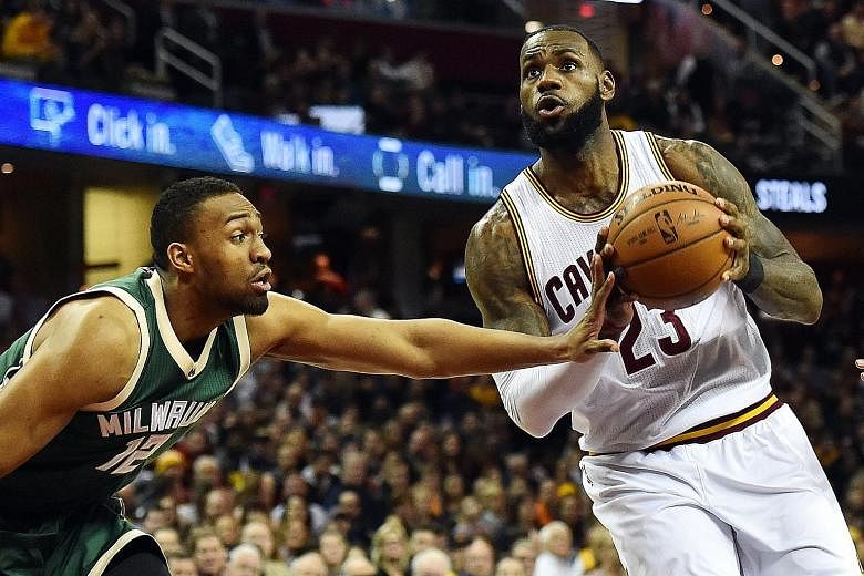 Cleveland Cavaliers' LeBron James driving to the basket against Milwaukee Bucks' Jabari Parker during the first quarter of the NBA game at Quicken Loans Arena. The Cavs won 113-102.