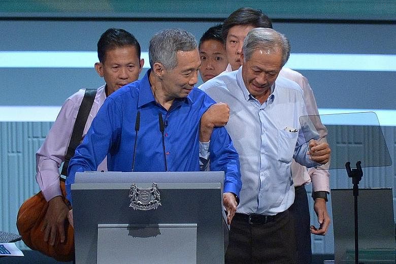 PM Lee (top) being helped by Defence Minister Ng Eng Hen during this year's National Day Rally, with Minister for Education (Schools) Ng Chee Meng and two security officers close behind. Minister Heng (above) being discharged from Tan Tock Seng Hospi