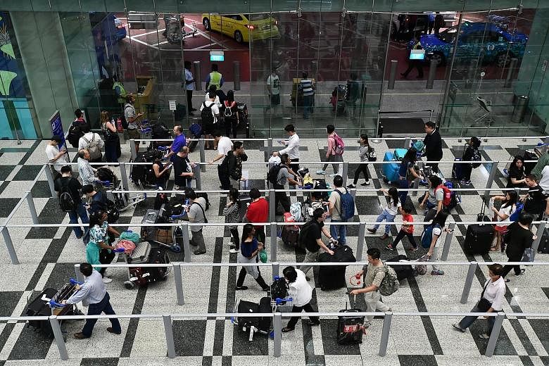 The taxi queue at Changi Airport's Terminal 3 yesterday. To ensure that things go smoothly amid the higher passenger volume, the airport has rolled out a series of measures, including deploying more staff and doing extra checks on self-service kiosks