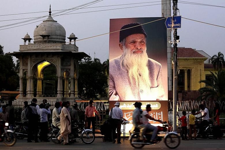 A portrait of Mr Edhi on display in Lahore on July 9 after his death. When asked why he was prepared to help people from all faiths, without prioritising Muslims over others, his response was "because my ambulance is more Muslim than you".