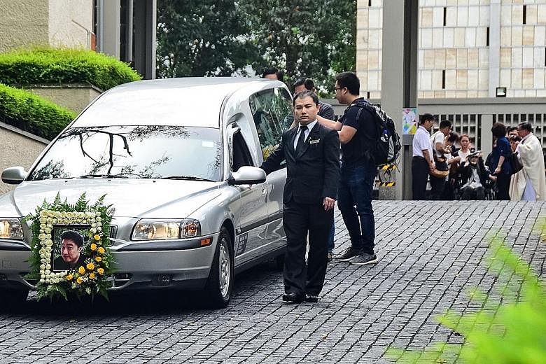 Among those at the funeral of Mr Jackie Liong at the Church of St Mary of the Angels in Bukit Batok (above) yesterday were his parents and his wife, who was injured in the crash. Ms Venny Oliver was in a wheelchair, her head wrapped in a scarf.