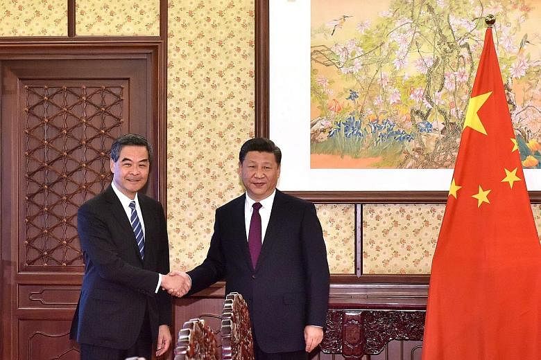 Outgoing Chief Executive Leung Chun Ying (on the left) with Mr Xi in Beijing yesterday. The Chinese President said he respected Mr Leung's decision not to stand for re-election and praised him for his work, such as curbing moves by some to promote in