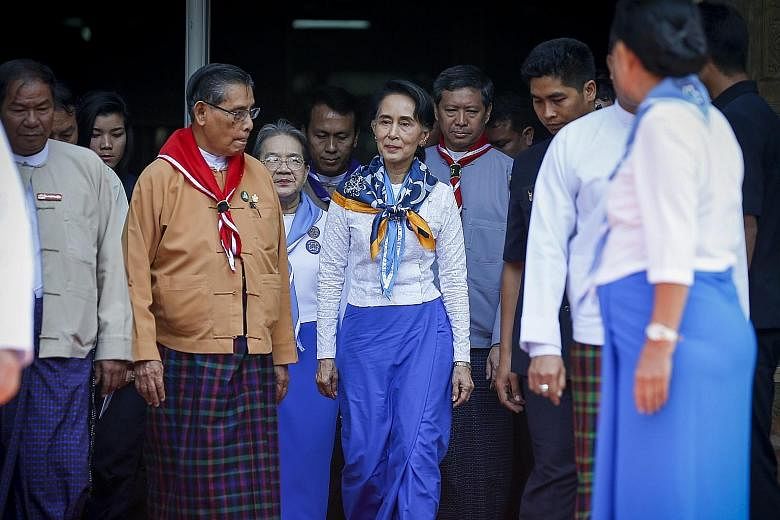 Myanmar State Counsellor and Foreign Minister Aung San Suu Kyi, wearing a girl scout uniform, leaving after attending the centennial anniversary of Myanmar scouting in Yangon yesterday. Scouting was first initiated in Myanmar in 1916. There are now m