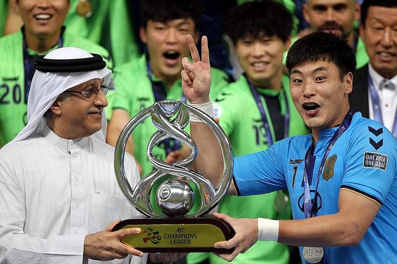 AFC president Sheikh Salman Ebrahim Al Khalifa presenting Jeonbuk's captain Kwoun Sun Tae with the trophy after the Korean club beat the UAE's Al-Ain 3-2 on aggregate in last month's final.