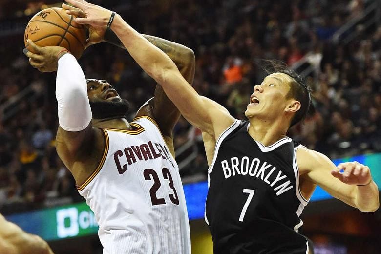 Cleveland forward LeBron James driving to the basket, as Brooklyn guard Jeremy Lin checks him during the first half of their game at Quicken Loans Arena. The Cavaliers won 119-99 while the Warriors downed the Pistons 119-113, setting up a mouth-watering C