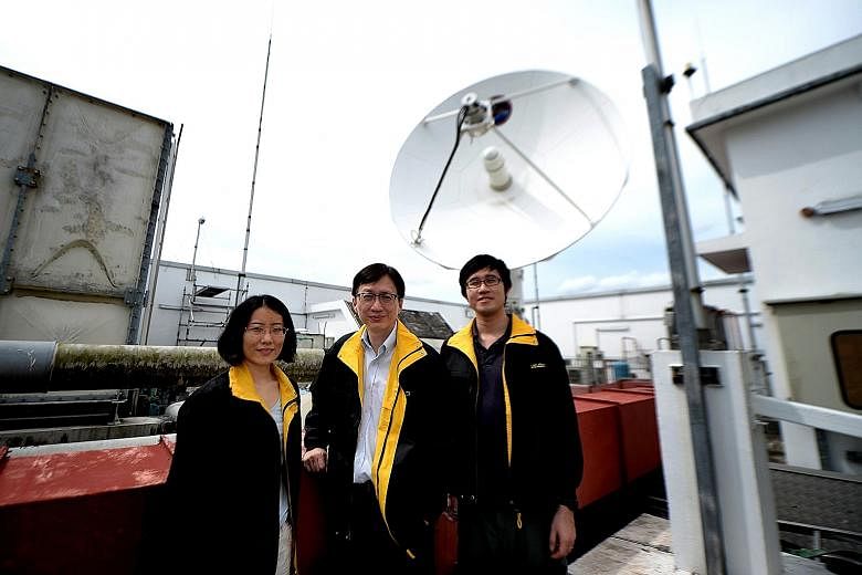 The Government has targeted the space and satellite sector for further growth to reach a higher orbit, with work done at the NTU Satellite Research Centre (above) helping to chart the journey forward. Mr Lim Wee Seng (centre), with researchers Li Bin