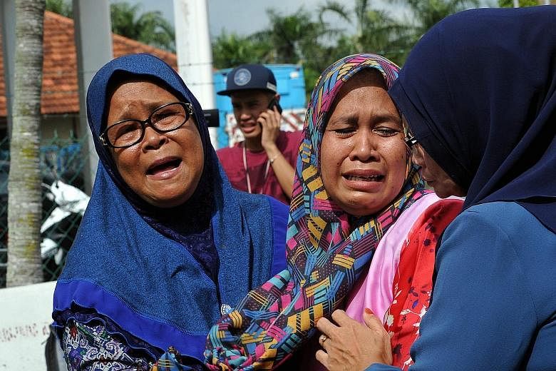 Madam Laila Kasdi (left), 62, mother of Ms Nor Saidatul Akmal Idris, and Madam Jamiah Saiman, 42, mother of Ms Nur Amira Izzaty Razip, at the Sultanah Fatimah hospital in Muar. Both their daughters died in the tragic crash. The Alisan Gold Coach bus,