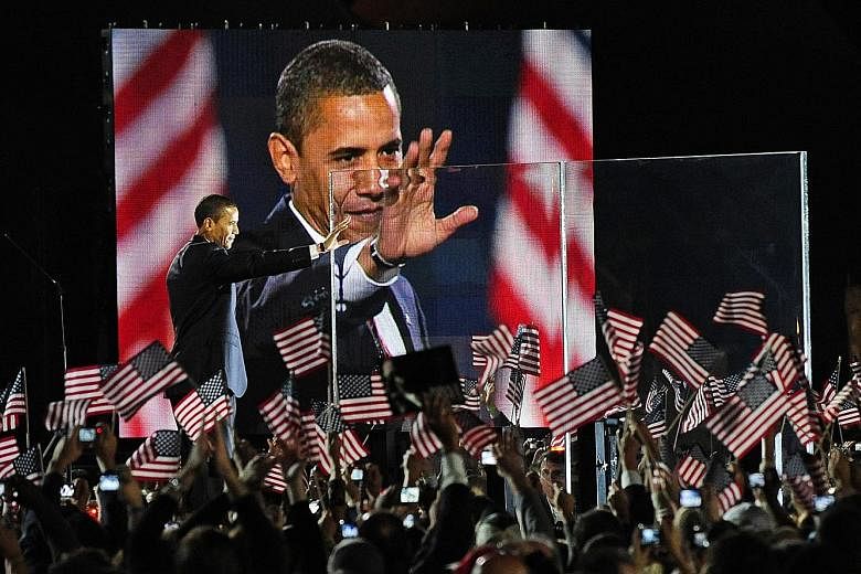 Mr Obama greeting his supporters at Chicago's Grant Park in 2008 after his election victory over Republican John McCain, making him America's first black president.
