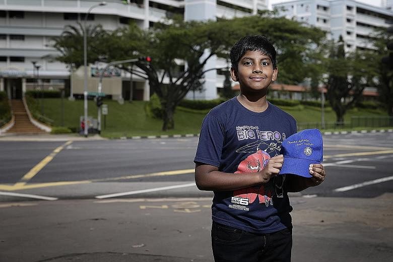 Ashvin with a cap inscribed with his name that was presented to him by Ms Yu as a token of appreciation for his help when she was involved in an accident in Yishun in May.