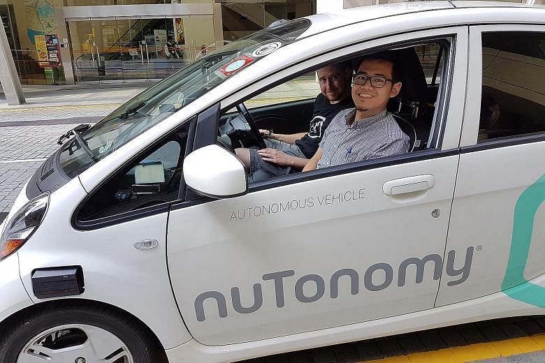 The reporter with nuTonomy safety engineer Greg Butron in the start-up's self-driving Mitsubishi i-MiEV.