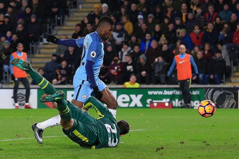 Manchester City's Kelechi Iheanacho taps home their second goal past Hull goalkeeper David Marshall, having come on as a substitute. City won 3-0 to stay seven points behind the league's pace-setters Chelsea.