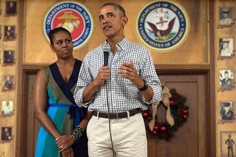 US President Barack Obama addressing troops with First Lady Michelle Obama at Marine Corps Base Hawaii in Kailua on Sunday. He is scheduled to meet Japanese Prime Minister Shinzo Abe in Hawaii.