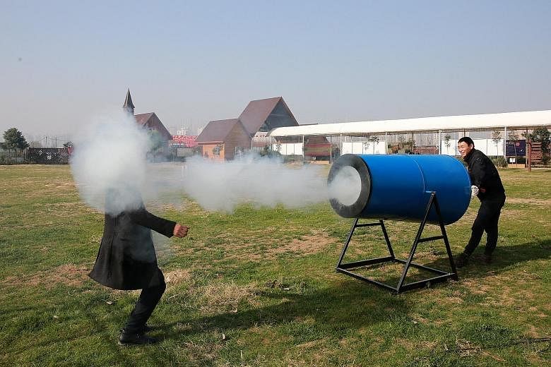 Cannon balls of water and tobacco tar fired from a "smog cannon" in Xiangyang, to raise awareness of the need to protect the environment.
