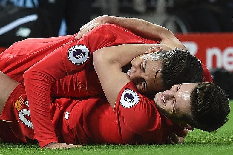 Liverpool's Roberto Firmino (top) celebrating with Adam Lallana after scoring the Reds' second goal against Stoke. Firmino had been a doubt to play after being arrested on Christmas Eve for drink driving.