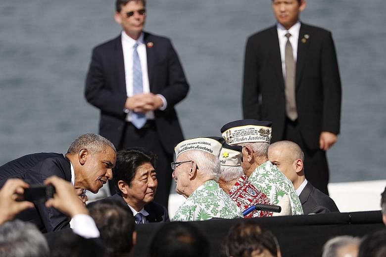 Mr Obama and Mr Abe meeting survivors of the 1941 Pearl Harbour attack, after visiting the USS Arizona Memorial in Hawaii on Tuesday (yesterday morning, Singapore time). Both leaders went to great lengths to expound on the Japan-US alliance, with Mr 