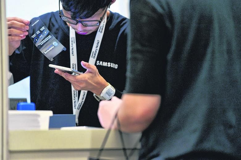 A Samsung representative serving a customer at The Crescent at the Suntec Singapore Convention and Exhibition Centre during the exchange arrangement for the Note7 in September. Globally, 2.5 million units were recalled.