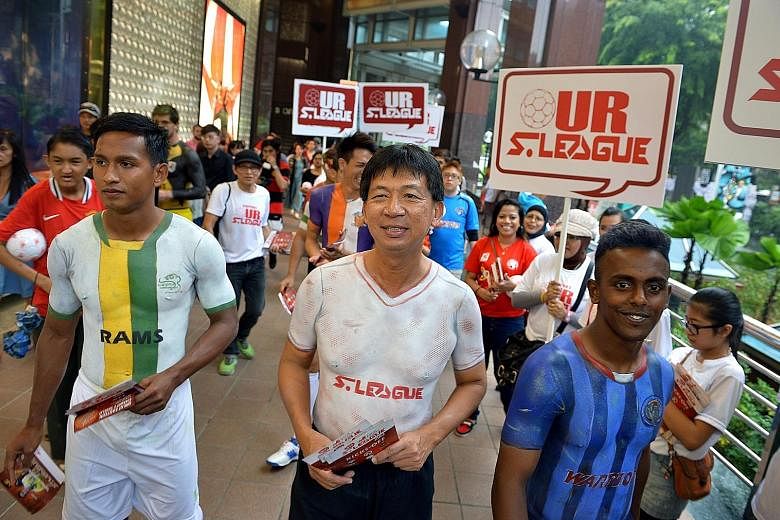 S-League CEO Lim Chin (centre) has participated in many promotional drives to boost the league, such as donning body paint with S-League players for a fan drive event at Orchard Road in 2013.