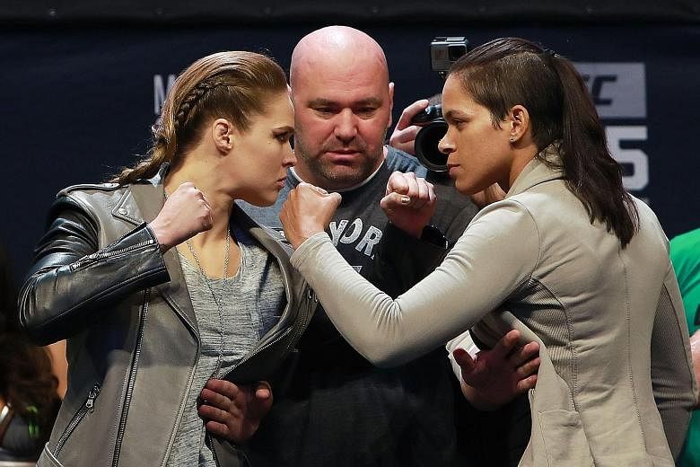 UFC women's bantamweight champion Amanda Nunes (right) in a face-off with Ronda Rousey after the weigh-in for tonight's fight in Las Vegas.