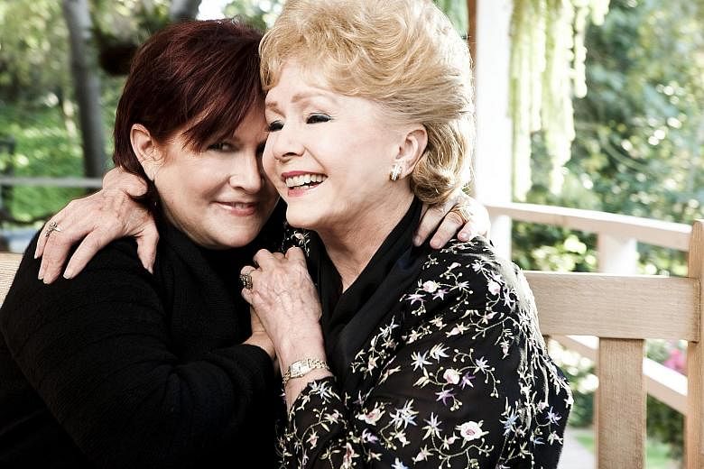 A 2010 photo of actress Carrie Fisher and her mother, Debbie Reynolds, at the former's home in Beverly Hills, California.