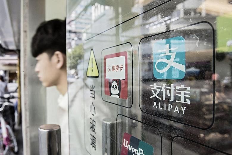 Signage for Ant Financial Services Group's Alipay payment system on a Shanghai store entrance. Potential large listings in Hong Kong next year include that of Alibaba arm Ant Financial, valued at US$60 billion (S$87 billion).