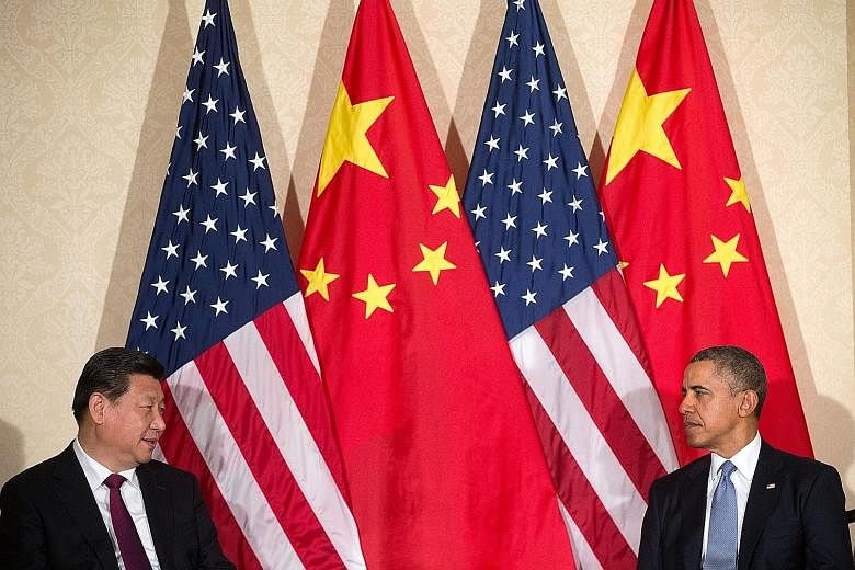 Mr Xi and Mr Obama at a meeting in the Netherlands in 2014. As America's influence declines, the steel-willed Chinese leader has risen above a shaky economy and the embarrassment of being all but declared an outlaw in the South China Sea to impose hi