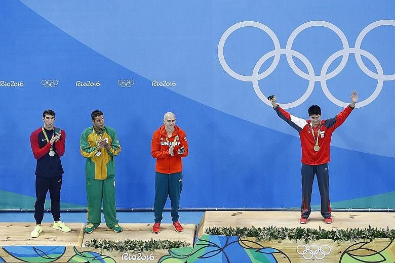 Schooling in Brazil earlier this year after winning the 100m butterfly. Tied for silver were (from left) Michael Phelps of the US, Chad le Clos of South Africa and Laszlo Cseh of Hungary.