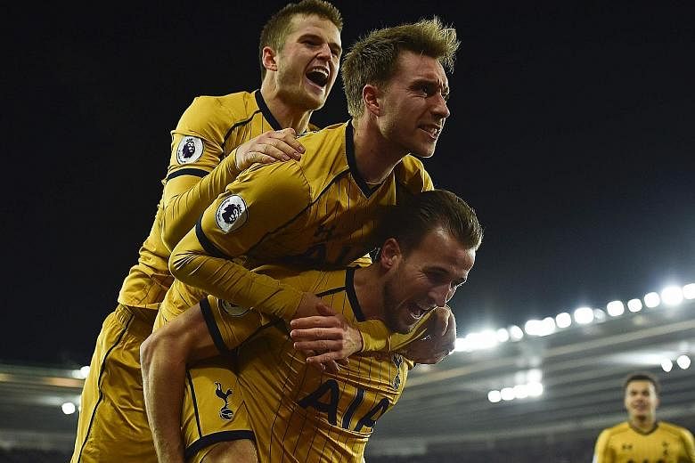 Tottenham striker Harry Kane (bottom) celebrating scoring their second goal against Southampton on Wednesday, with midfielder Christian Eriksen (centre) and defender Eric Dier. Spurs' 4-1 win has spurred confidence that they can cut Chelsea's big lea