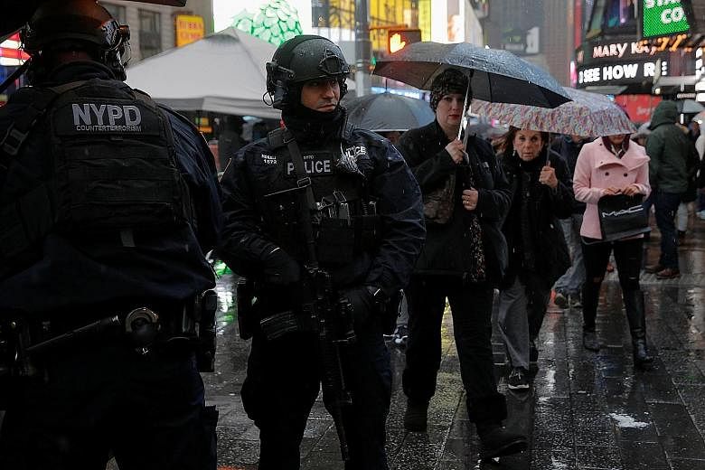 New York counter-terrorism police officers on patrol in Times Square on Thursday, where more than a million people are expected to gather for tonight's countdown party.