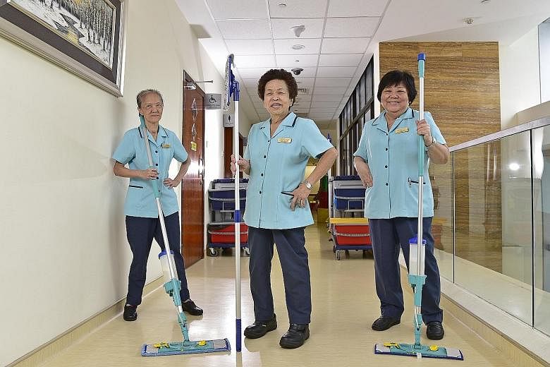 Cleaner Wong Kim Fong (centre) started work at Mount Alvernia Hospital 55 years ago, while her colleagues Lim Ah Bee (left) and Tan Kim Yeok have both worked at the hospital for 45 years. They say they are loath to leave their workplace.