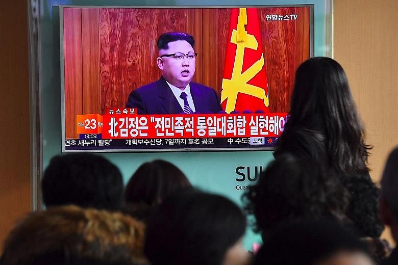 North Korean leader Kim Jong Un giving a New Year speech during a television news broadcast at a railway station in Seoul.