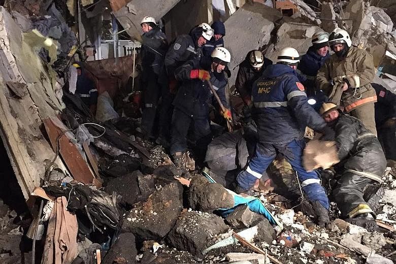 Rescuers removing debris from the collapsed building in central Kazakhstan yesterday.
