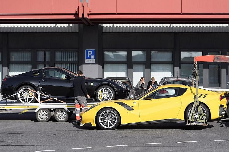 Two Ferrari cars (left) belonging to Obiang (above) being towed away by police at Geneva Airport, in Switzerland, on Nov 3.
