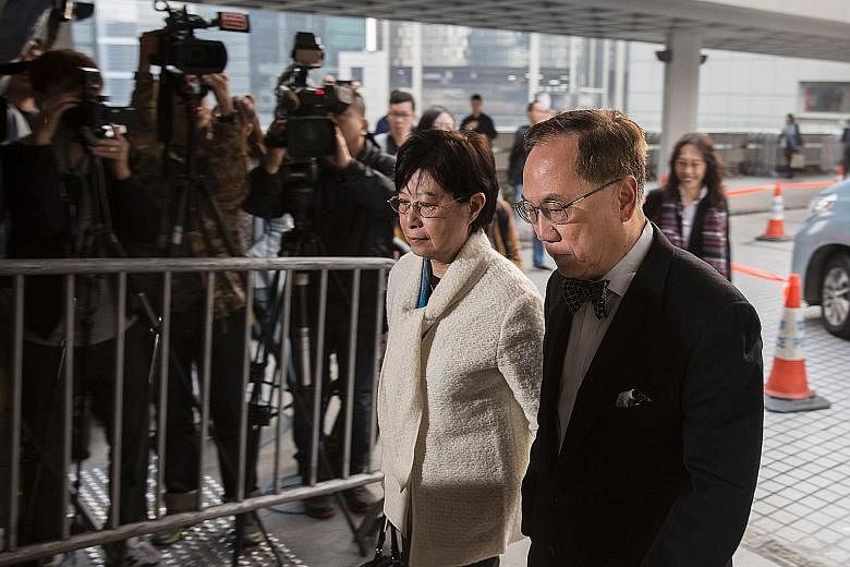 Tsang arriving at the High Court with his wife yesterday for the first day of his corruption trial. He pleaded not guilty to three charges of misconduct and bribery. The hearing is expected to last 20 days.