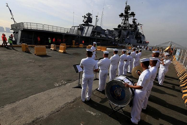 Band members from the Philippine Navy welcoming the anti-submarine destroyer Admiral Tributs, which docked in Manila yesterday. Philippine President Rodrigo Duterte has said he is willing to hold war games with Russia.