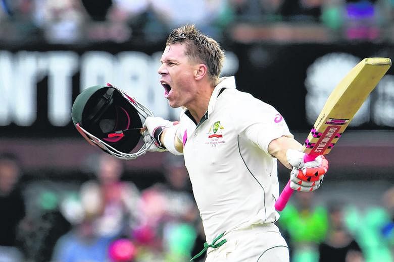 Australia's David Warner celebrates scoring a century against Pakistan during the first day of the third cricket Test match.