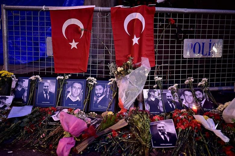 Left: A picture released by the Turkish police on Monday shows the main suspect in the Reina nightclub rampage. Left: Flowers and pictures of the victims were placed near the entrance of the nightclub on Monday to remember those who were killed in th