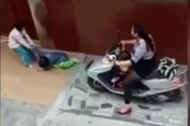 A video shot by an eyewitness shows the woman's child dragging the injured girl, before the woman rides her scooter over her again.