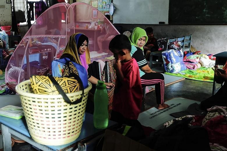 Evacuees at a relief centre in the town of Rantau Panjang yesterday.