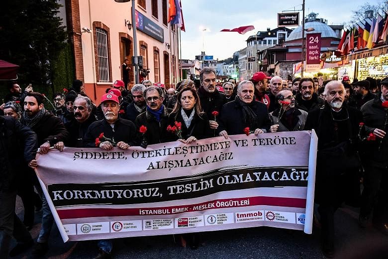 Turkish union members marching with a banner that reads, "We will not get used to terrorism", in Istanbul on Tuesday. Sunday's shooting followed a year of attacks in Turkey, in which hundreds of people were killed.