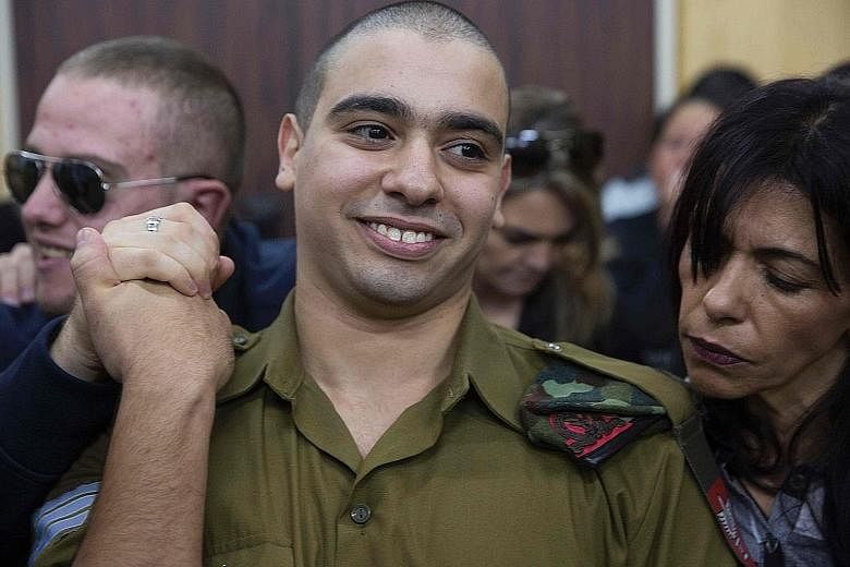 Azaria awaiting his verdict in a military court yesterday. The soldier has been on trial for manslaughter since May, with right-wing politicians defending him despite top army brass harshly condemning the killing.