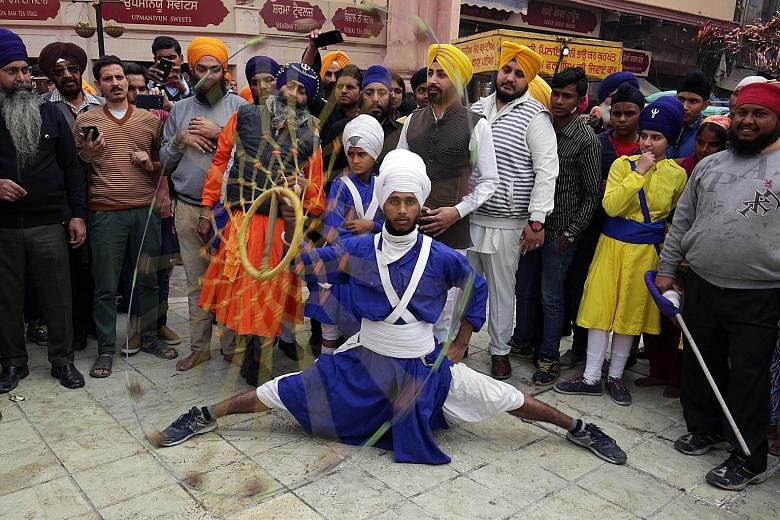 A man performing the Sikh martial art form of Gatka. He was taking part in a religious procession in Amritsar yesterday that marked the 350th anniversary of the birth of the 10th Sikh Guru, Sri Guru Gobind Singh, who initiated the sect of Khalsa Pant