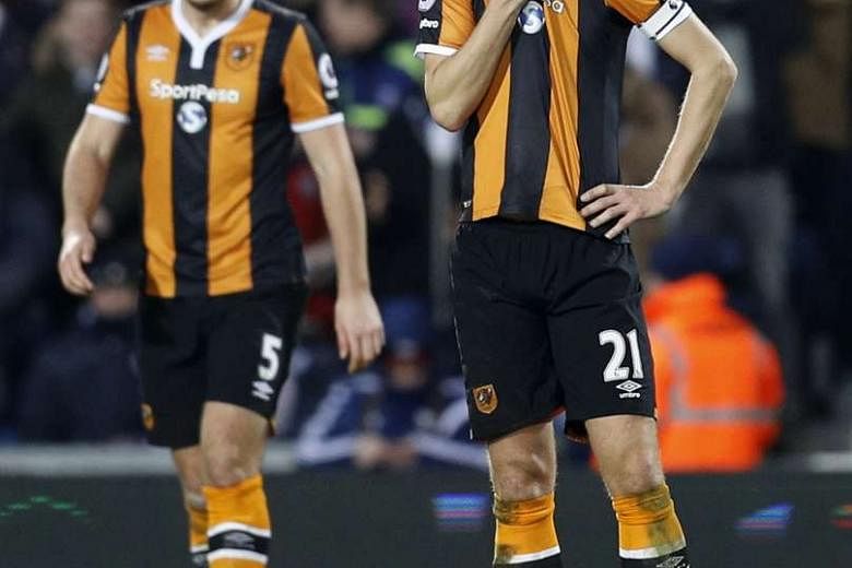Hull City's Michael Dawson (right) looking dejected after their 1-3 loss to West Bromwich Albion on Monday. The result triggered the departure of manager Mike Phelan. 