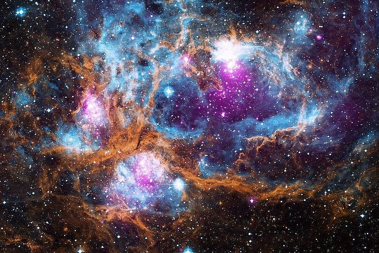 This is a region called NGC 6357 where radiation from hot, young stars is energising the cooler gas in the cloud that surrounds them. Located in a galaxy about 5,500 light years from Earth, NGC 6357 is a "cluster of clusters", containing at least thr