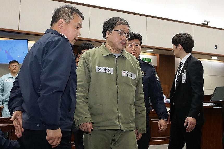 Choi (in beige) appearing on the first day of her trial at the Seoul Central District Court yesterday. She is accused of colluding with Ms Park, whose powers have been suspended, to pressure big businesses into contributing to non-profit foundations 
