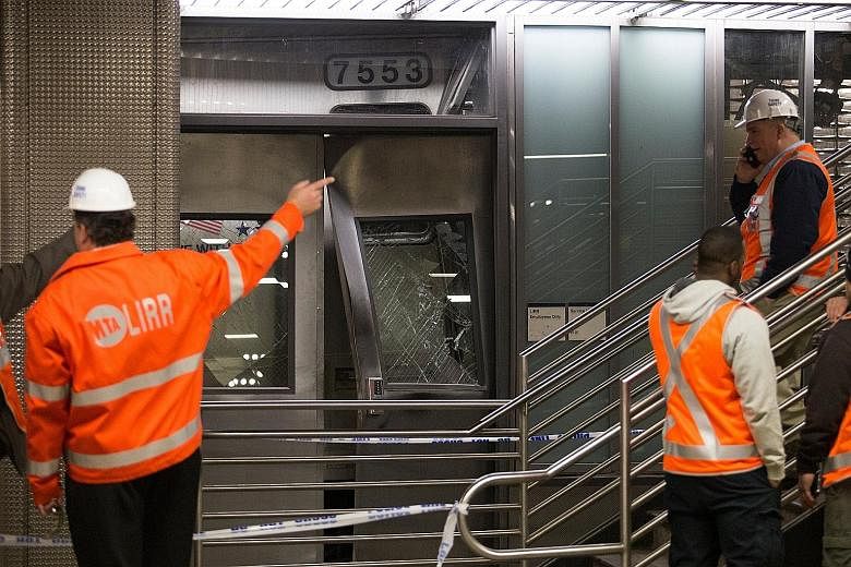 Officials inspecting the Long Island Rail Road train that derailed after striking a bumping block at Atlantic Terminal in Brooklyn on Wednesday. About 430 passengers and three crew members were on board at the time of the collision.
