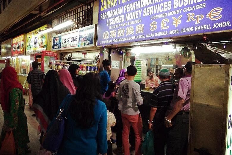 A money changer in Larkin, Malaysia. One reason the ringgit is set to fall further is that it is affected by the Chinese yuan, which is going to remain under downward pressure, according to BMI Research. Further weakness in the global bond market wou