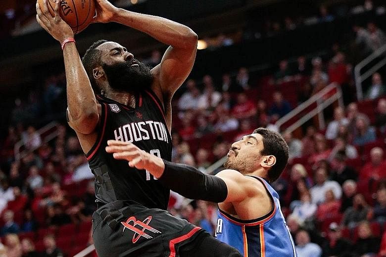 James Harden is fouled by Oklahoma's Enes Kanter as he drives to the basket at Toyota Centre. The Houston guard posted 26 points, 12 assists and eight rebounds - just missing out on a fourth straight triple double.