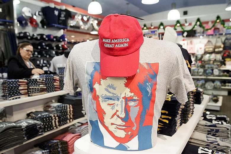 Above: A ticket for the US presidential inauguration ceremonies on Jan 20. Russian officials allegedly celebrated Mr Trump's victory in last year's election. Left: A T-shirt with an image of US President-elect Trump on display at a tourist shop in Ne